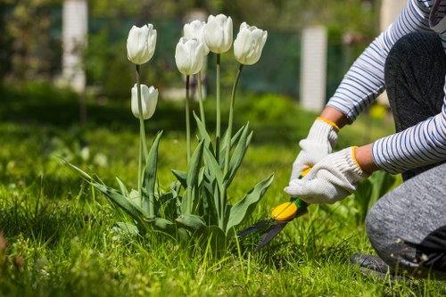 Technician preparing pressure washing equipment near a property exterior